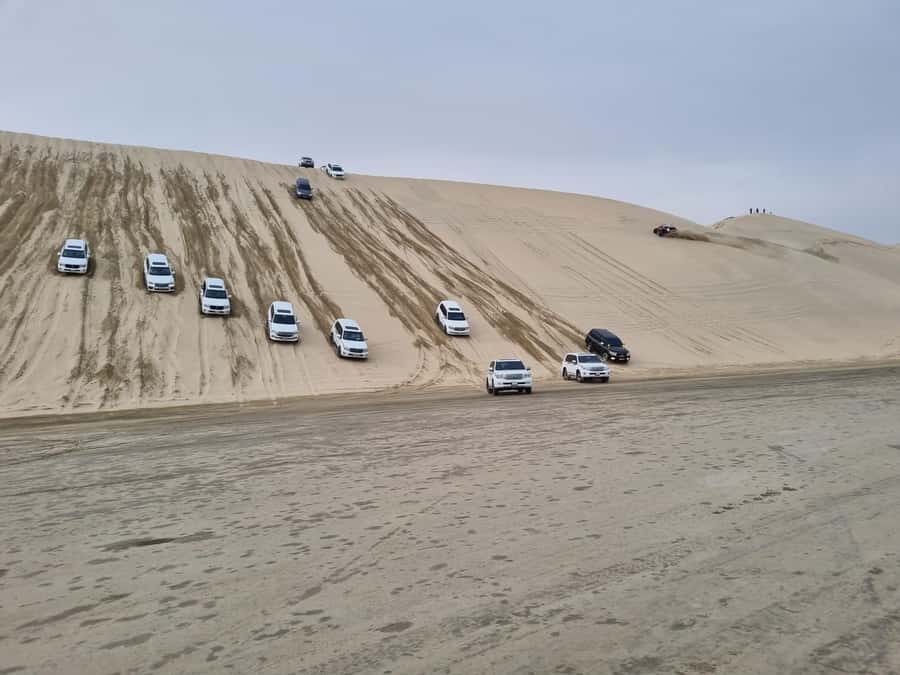 Doha: Sunset desert tour with Camel Ride, Inland Sea & Tea - Mesaieed camel ride: short, fun, and very “Qatar desert”