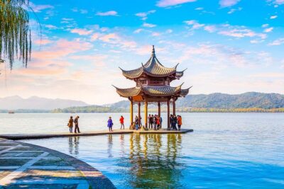 Private Hangzhou Day Tour to West Lake, Lingyin Temple, Tea Village, Old Pagoda - Lingyin Temple at Fei Lai Feng: stones, trees, and grotto atmosphere